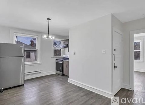 A kitchen with a refrigerator, a dishwasher, and a stove top oven.
