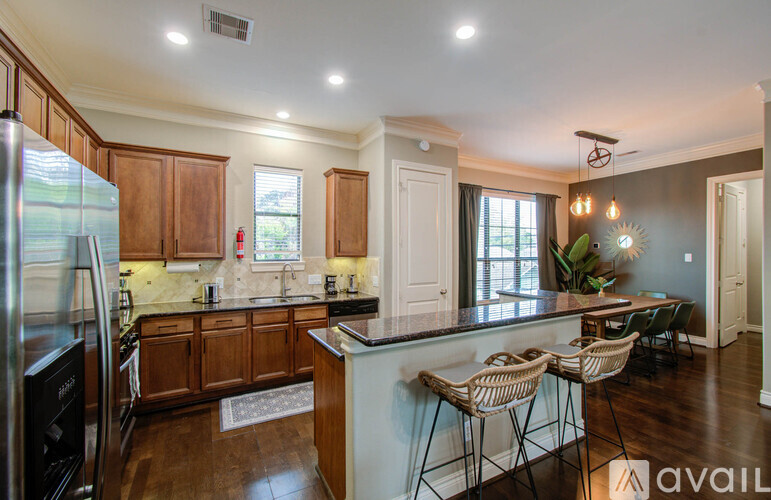 A kitchen with wooden cabinets and a marble countertop.