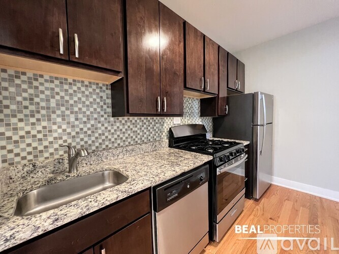 A kitchen with a black stove and a black refrigerator.