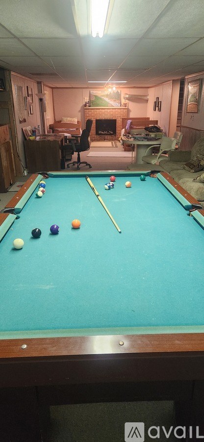 A pool table with balls set up for a game.
