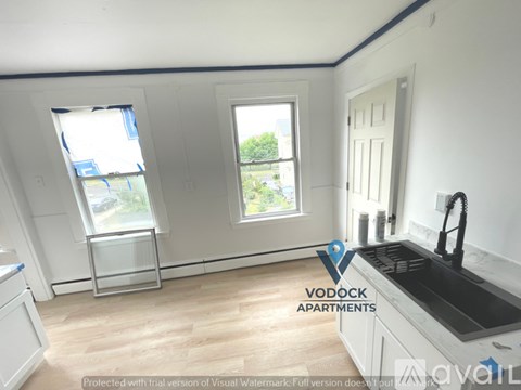 A kitchen with a sink and a window.