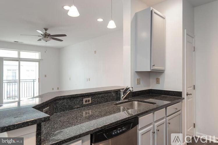 A kitchen with granite countertops and stainless steel appliances.