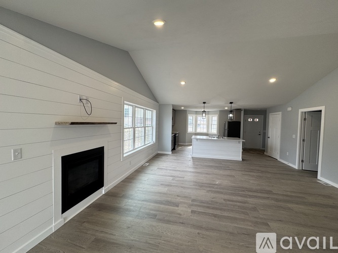 A spacious living room with a fireplace and a television.