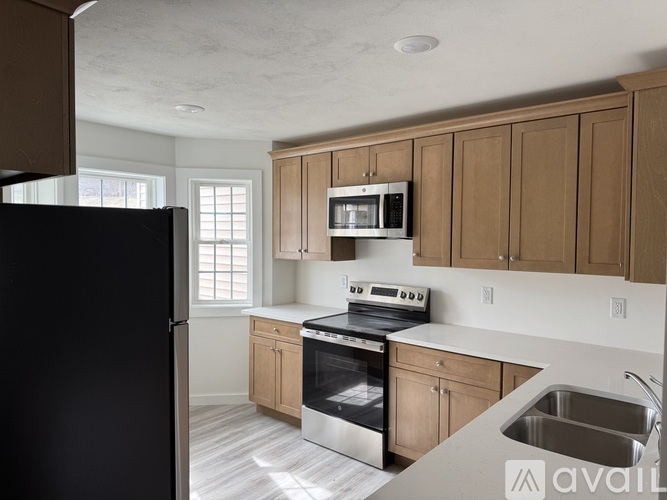 A kitchen with wooden cabinets and stainless steel appliances.