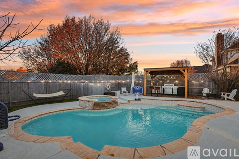 A backyard with a pool and a deck.