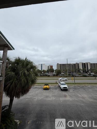 A yellow car is parked in a lot with other cars.