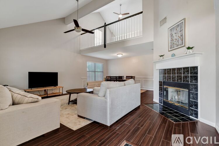 A living room with a fireplace and a television.