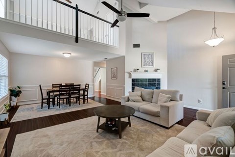 A living room with a dining table and a couch.