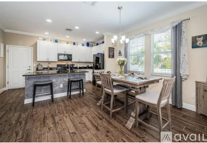 A kitchen with a dining table and chairs.