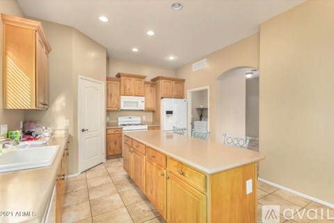 A kitchen with wooden cabinets and appliances.
