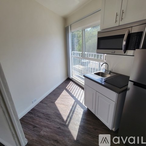 A kitchen with a sink and a refrigerator.