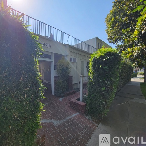 A building with the number 4914 on it is surrounded by greenery.