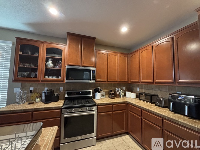 A kitchen with brown cabinets and appliances.