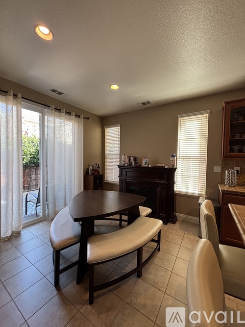A dining room with a table and chairs.