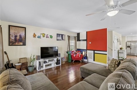 A living room with a grey sofa and a television.