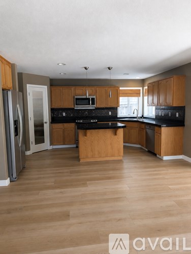 A kitchen with wooden cabinets and a central island.