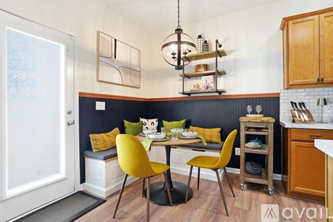 A kitchen with a dining table and chairs.