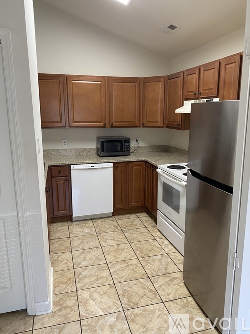 A kitchen with a white fridge, white dishwasher, and white microwave.