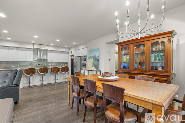A dining room with a wooden table and chairs.