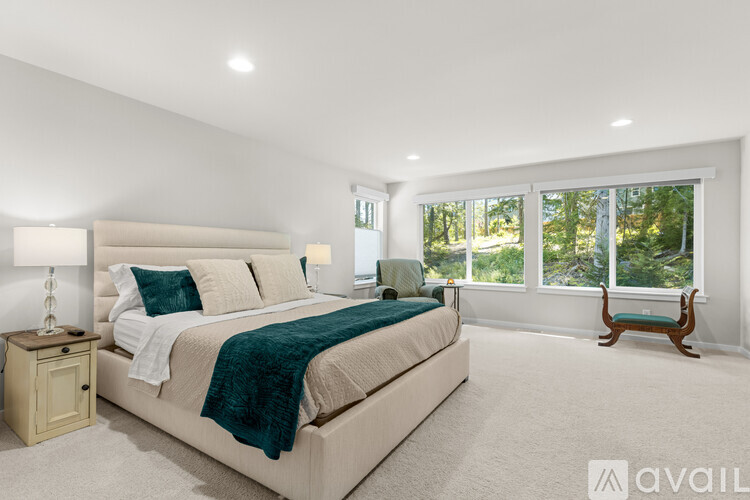 A bedroom with a large bed and a window seat.