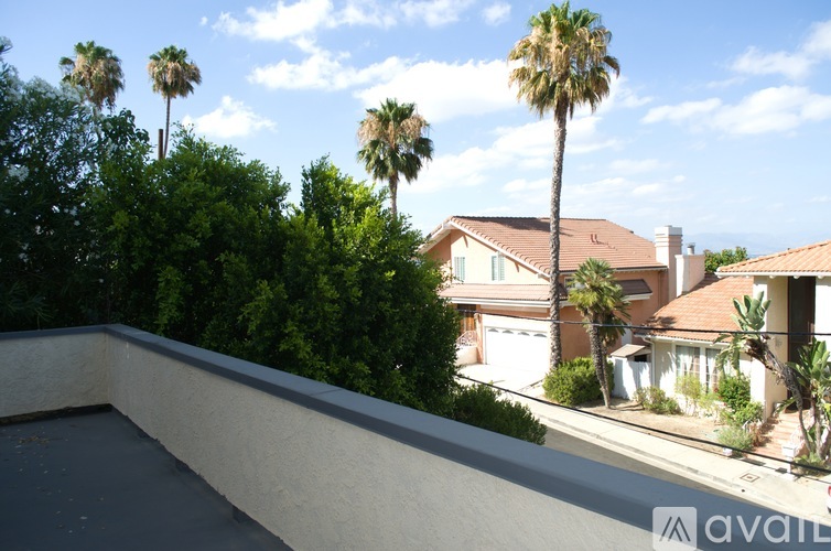 A house with a pool and palm trees in the background.