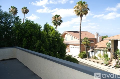 A house with a pool and palm trees in the background.