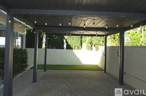 A covered walkway with lights strung from the ceiling.