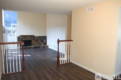 A living room with a fireplace and a balcony.