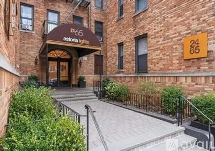 The image shows the front of a building with a sign that reads "24/65 astoria lights".