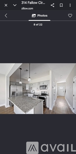 A kitchen with a granite countertop and stainless steel appliances.