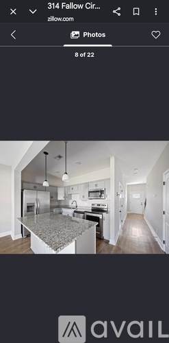 A kitchen with a granite countertop and stainless steel appliances.