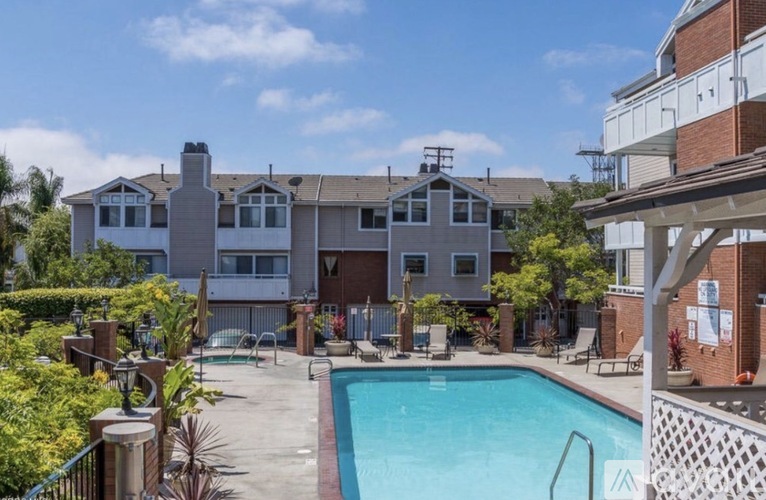 A pool area with a building in the background.