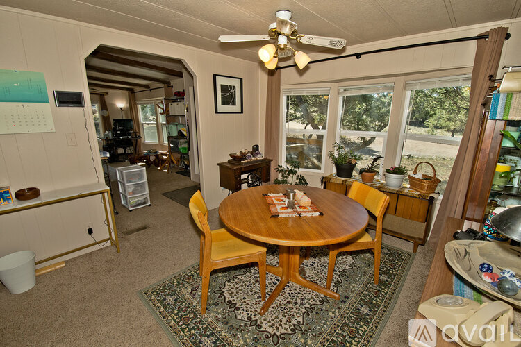 A living room with a table and chairs.