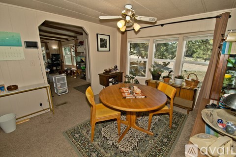 A living room with a table and chairs.