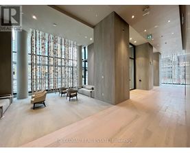 A spacious lobby with a seating area and large windows.