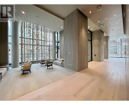 A spacious lobby with a seating area and large windows.