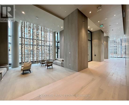 A spacious lobby with a seating area and large windows.