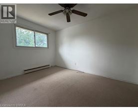 A room with a ceiling fan and a window.