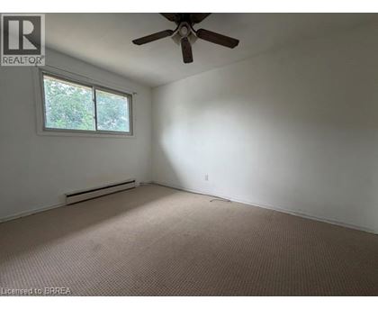 A room with a ceiling fan and a window.