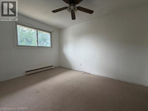 A room with a ceiling fan and a window.