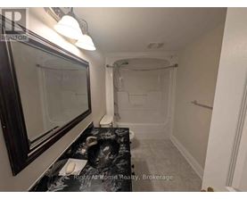 A bathroom with a walk-in shower and a sink.