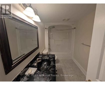 A bathroom with a walk-in shower and a sink.