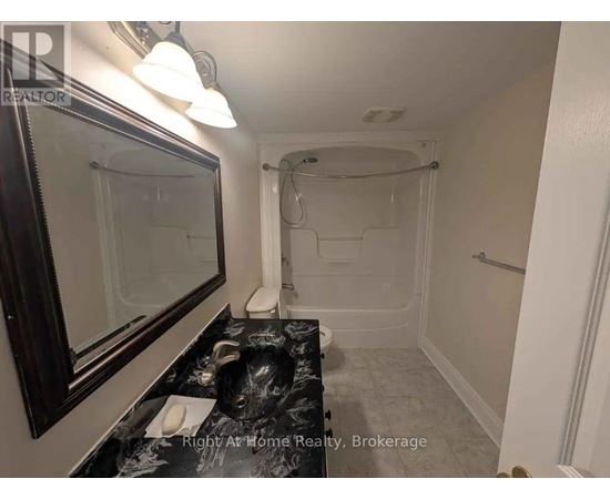 A bathroom with a walk-in shower and a sink.