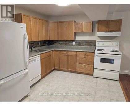 A kitchen with wooden cabinets and white appliances.