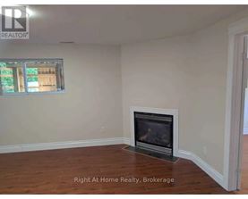 A room with a fireplace and a window.