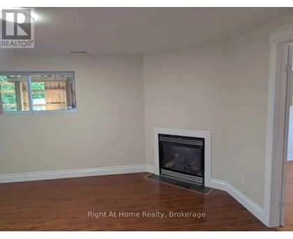 A room with a fireplace and a window.