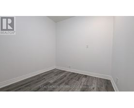 A room with a wooden floor and white walls.