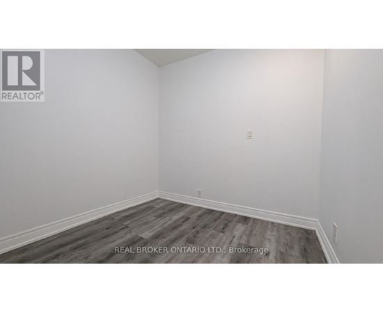 A room with a wooden floor and white walls.