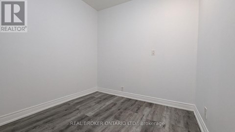 A room with a wooden floor and white walls.