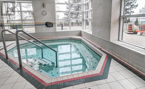 A hot tub in a room with a window.